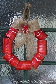 a wreath made out of cans is hanging on the front door