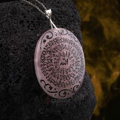 This elegant rose quartz necklace is the perfect blend of spiritual and fashionable. The 99 names of Allah, engraved onto the pendant, is a powerful reminder of the many qualities and attributes of the divine. The rose quartz is believed to bring love, healing, and inner peace, making this necklace not just a beautiful piece of jewelry, but also a powerful tool for spiritual growth. The natural and raw rose quartz gives it a natural and organic look, making it perfect for everyday wear. This necklace is not only a fashion statement but also a powerful reminder of one's faith. Are you looking for a truly unique and special piece of jewelry? Look no further than handmade necklaces! Our Handmade necklaces are crafted by skilled artisans who put their time, passion, and creativity into each pi Pink Spiritual Pendant Crystal Necklace, Spiritual Pink Pendant Crystal Necklace, Spiritual Rose Quartz Round Pendant Necklace, Pink Spiritual Jewelry For Blessing, Pink Amulet Necklace For Gift, Engraved Spiritual Necklaces For Healing, Handmade Rose Quartz Spiritual Necklace, Traditional Crystal Necklaces With Natural Stones For Gifts, Pink Engraved Round Necklace