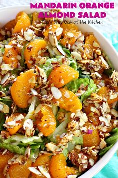 mandarin orange salad in a white bowl with almonds