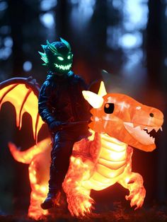 a man standing next to a glowing dragon