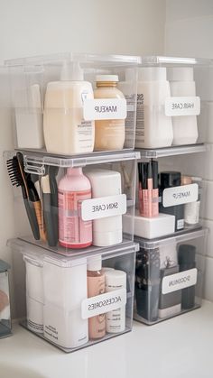 three plastic containers with labels on them are sitting on the counter in front of a sink