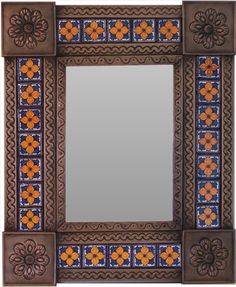 a decorative mirror with an orange and blue design on the border, in front of a white background