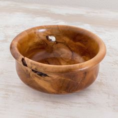 a wooden bowl sitting on top of a table