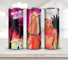 three different colored cans with the same image on them, one in pink and one in orange