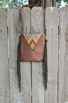 Crossbody or shoulder big fringe bag. Orange, brown & taupe rug compliments this bohemian design. The backside is brown canvas with a deep 9" zip pocket. It has a leather adjustable strap. Top zip to keep your goods safe. Fully lined with an inside zip pocket. Measures 11" x 11".  The fringe measures 12" long and sits 11-12" below the bottom of the bag. Fringe is unique :, some are short, some long. Free Domestic shipping!. Beige Leather Bags With Fringe, Bohemian Crossbody Satchel With Fringe, Brown Tassel Bags For Daily Use, Bohemian Fringe Crossbody Satchel, Rectangular Brown Satchel With Tassels, Brown Tassel Crossbody Shoulder Bag, Brown Crossbody Shoulder Bag With Tassels, Brown Bohemian Satchel With Fringe, Bohemian Brown Fringe Satchel