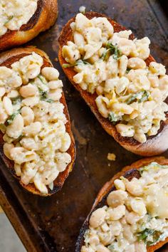 four pieces of bread topped with macaroni and cheese