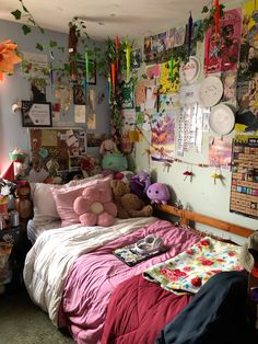 a bedroom with lots of stuffed animals on the wall and decorations hanging from the ceiling