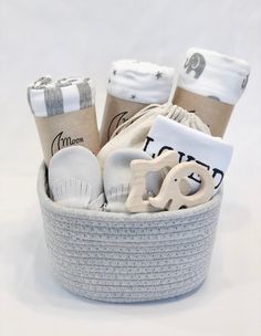 a basket filled with baby items sitting on top of a white table