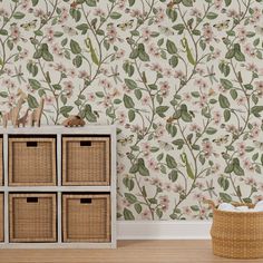 a wallpapered room with flowers and baskets on the floor, next to a wicker basket