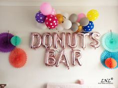 there is a sign that says donut's bar and balloons on the wall