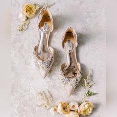 the bride's wedding shoes and flowers are laid out