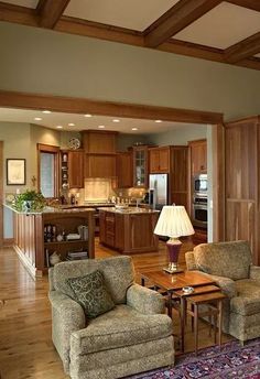 a living room filled with furniture next to a kitchen