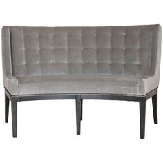 a gray couch sitting on top of a wooden frame