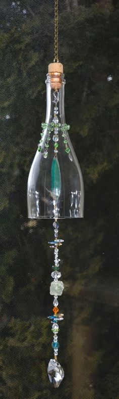 a glass bottle hanging from a chain on a window sill