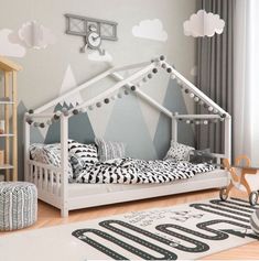 a child's bedroom with a white bed and black and white decor on the walls