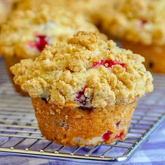 a muffin with crumbs on top sitting on a cooling rack