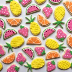 some decorated cookies with different types of fruit on top of each other, including pineapples, watermelon, and strawberries