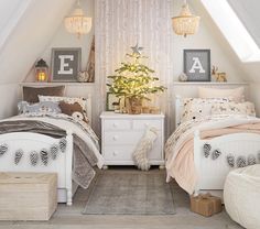 two beds in a room with white furniture and decorations on top of the headboards