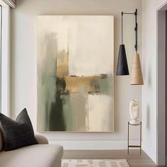 an abstract painting hangs on the wall next to a couch in a modern living room