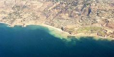 an aerial view of the ocean and land