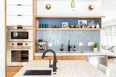 a kitchen with an oven, sink and microwave in it's center island area