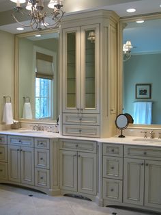 a large bathroom with double sinks and mirrors