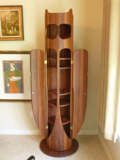 a tall wooden cabinet sitting in the corner of a room