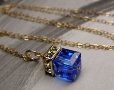 Give a stunning royal blue necklace to a woman who loves modern and elegant jewelry.  This minimalist design delivers maximum oomph in a spectacular popular blue hue. She can dress up anything with this bright sapphire blue necklace. Perfect gift for women born in September since sapphire is one of her birthstone.Swarovski crystal cube pendants come in all birthstone colors and neutrals. Give an elegant yet personal gift to all the women in your life. Adjustable necklace for the perfect fit ever Cube Pendant, Blue Crystal Necklace, Bridal Party Jewelry, Cube Necklace, Blue Crystal Earrings, Birthstone Colors, Bridesmaid Wedding, Bridesmaid Necklace, September Birthstone