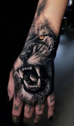 a man's hand with a wolf tattoo on it, and an orange eye