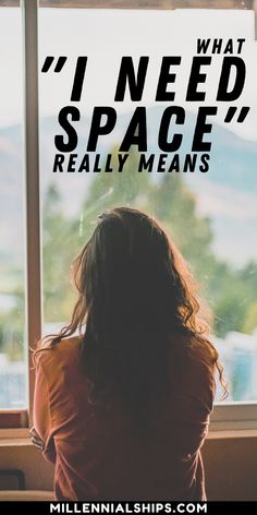 a woman sitting in front of a window with the words i need space really means