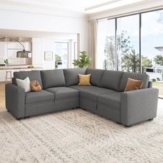 a living room with a sectional couch and large windows