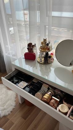 a white vanity with drawers and mirrors on it