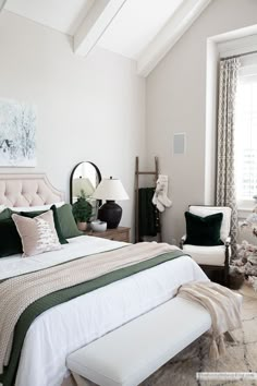 a bedroom with white walls and green accents