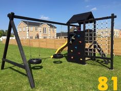 a child's play area in the back yard with a swing set and tire tires