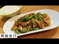 a white plate topped with green beans and rice