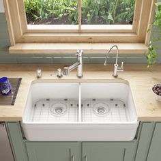 a kitchen sink sitting under a window next to a counter