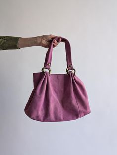 Pink suede shoulder bag featuring round gold metallic details, a magnetic clasp closure, and an interior zip pocket. This tote, dating from the 90s to early 2000s, is in good used condition, perfect for adding a subtle pop of color to your everyday look. Brand: GAP Fabric: 100% leather Dimension: 13 x 10 x 5 inches 🛍️ Shop the outfit: Shoes: https://www.etsy.com/uk/listing/1809908839/ Skirt: https://www.etsy.com/uk/listing/1745571887 Jacket: https://www.etsy.com/uk/listing/1795703080 Bag charms 90s Bags, 90s Bag, Pink Suede, Metallic Accents, Gap, Suede Leather, Leather Tote, Everyday Look, Purses And Handbags