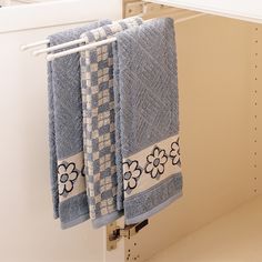 towels are hanging on the towel rack in this kitchen