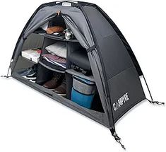 an open tent with shoes and other items in it on a white background for use as a storage compartment