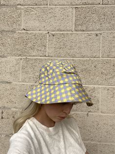 Yellow + Lavender Plaid Bucket Hat with adjustable string on the inside. one size Model is 5'9" Spring Adjustable Fit Bucket Hat, Adjustable Fit Spring Bucket Hat, Trendy Adjustable Bucket Hat With Curved Brim, Adjustable Fit Brimmed Bucket Hat For Spring, Spring Adjustable Fit Brimmed Bucket Hat, Spring Adjustable Brimmed Bucket Hat, Trendy Adjustable Flat Brim Bucket Hat, Adjustable Cotton Bucket Hat One Size, Spring Wide Brim Bucket Hat With Adjustable Fit