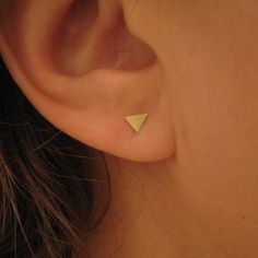 These super tiny triangle stud earrings are one of our geometric shape series that will be perfect for everyday wear. 14k solid gold triangle stud earrings with a beautiful brushed matte finish. Earrings have 14k gold butterfly ear backs which hold them safely. + 14k Gold, sterling silver, or brass Triangles measuring 4mm, 6mm, & 11mm + Matte or Polished Finish + Earring Posts are 20ga Sterling silver, or 14k Gold and 10mm long + 14K Gold, Sterling silver Butterfly Backs + Packaged in a Kraft Bo Gold Triangle, Triangle Earrings Stud, Rose Gold Studs, Triangle Studs, Geometric Studs, Bar Studs, Earring Gift, Small Earrings Studs, Gold Stud