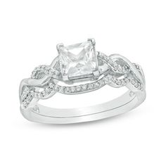 an engagement ring with a princess cut diamond in the center and two rows of diamonds around it