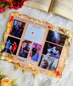 an open book with pictures on it next to flowers