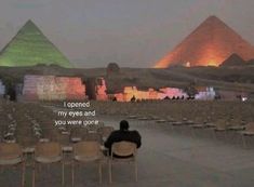 a man sitting on a chair in front of two pyramids with the caption, i opened my eyes and you were gone