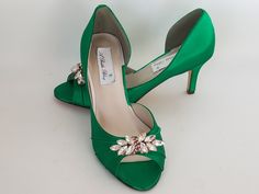 "Emerald Green Wedding Shoes with a sparkling crystal Rose Gold applique. Perfect shoes for your special day. The listing picture shoes a comfortable 2 1/2 inch heel (also available in 1 3/4 inch heel). The shoes in the listing have been dyed Emerald Green, but is also available in over 100 different colors as well as the option of sending us a sample to color match for you! If you would like a different heel size than the listing heel size of 2 1/2 inches, please leave us a note at checkout or Green Rhinestone Wedding Heels, Green Rhinestone Heels For Wedding, Emerald Green Wedding Shoes, Green Bridal Shoes, Sparkle Wedding Shoes, Emerald Green Wedding, Blue Bridal Shoes, Gold Wedding Shoes, Ivory Bridal Shoes