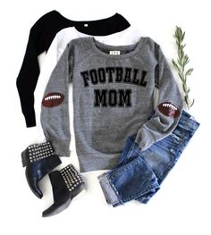 a football mom sweater and jean shorts with high heel boots on the floor next to it