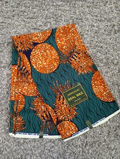 Beautiful African/ Ankara print made of good quality fabric (100% cotton). The material is a beautiful mix of green and orange colors, decorated with pine-apple shaped patterns. Dimension available - 3 yards /6 yards width: 44-45 inches length: 35-36 inches per yard Use: it is ideal for your craft/ sewing projects, dresses, bags, home decor, quilts, upholstery etc Maintenance: Hand wash or Machine wash at low-medium spin with cold water and mild detergent. Note: Please note that the fabric colou Traditional Green Printed Fabric, Traditional Green Fabric With Colorful Pattern, Green Traditional Fabric With Colorful Pattern, Green Ankara Fabric, Green Ankara Fabric With Colorful Pattern, Green Printed Ankara Fabric, Black Ankara Fabric With Colorful Pattern, Colorful Green Ankara Fabric, Orange Ankara Fabric With Batik Print