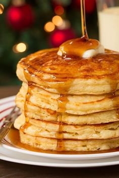 a stack of pancakes with syrup and butter on top