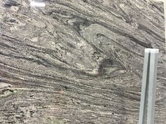 a close up view of a granite countertop with grey and white marbles on it