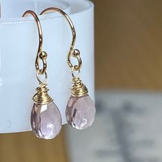 Handmade Morganite Quartz earrings, 14k Gold drops. Pale Pink peach Tiny Morganite dangles. Gems are wire wrapped in gold and suspended on Handmade French hooks. Simple, lightweight, minimalist style. Great for everyone and every day and dressy enough for special occasions. Beautiful, faceted, pink Peach Morganite Quartz pear shaped gems measure 9 mm each. The earrings measure approximately 1 inch long. Heart chakra stone, be open to love and give love. Available in sterling silver, tarnished st Dainty Pink Dangle Earrings, Open To Love, Morganite Necklace, Give Love, Peach Morganite, Bling Earrings, Mixed Metal Jewelry, Pink Gem, Pink Peach